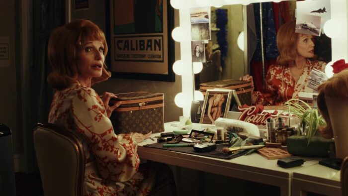 Kathleen in her dressing room with her reflection in the mirror