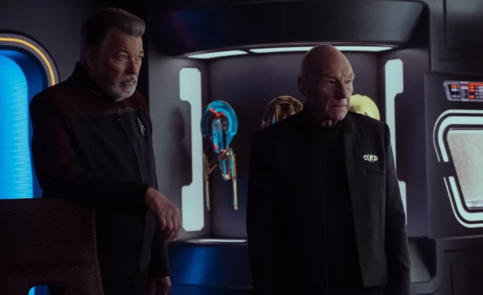Riker and Picard stand in front of some model starships