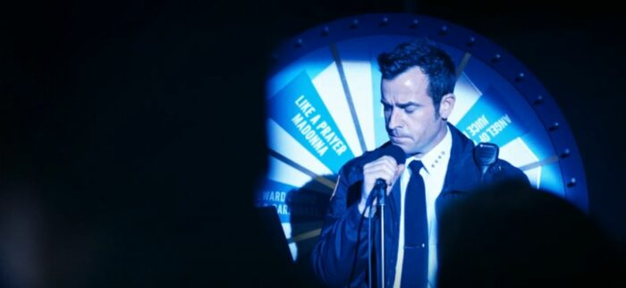 Kevin in front of a wheel, singing karaoke