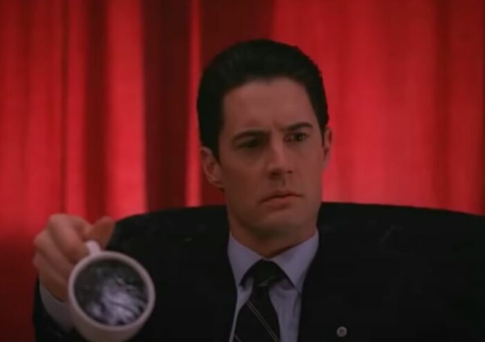 Dale Cooper holds a cup of coffee that appears solid in the Red Room in Twin Peaks