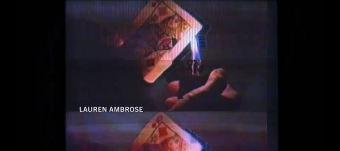 A lighter being held to the queen of diamonds in the Yellowjackets Season 2 opening credits