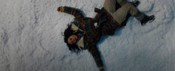 Teen Lottie lies on the snow