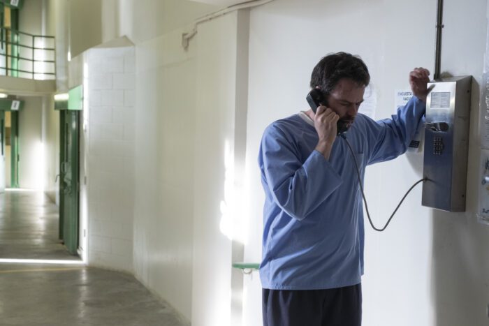 Barry making a call from prison