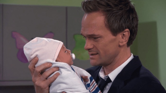 Barney holding his newborn daughter