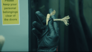 A gloved hand holding a string