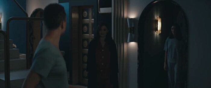 Elliot, Bev and Genevieve stand in the Mantles' apartment