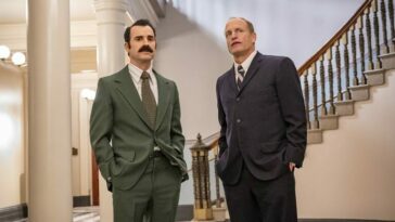 Woody Harrelson and Justin Theroux stand side by side wearing suits in White House Plumbers on HBO