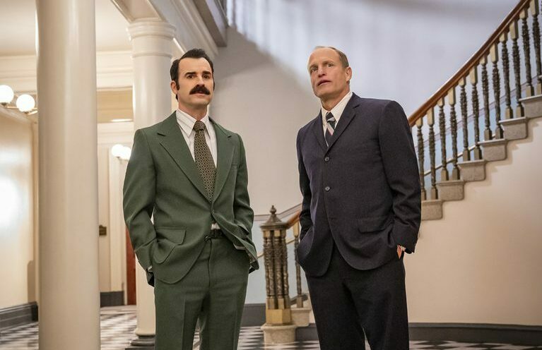 Woody Harrelson and Justin Theroux stand side by side wearing suits in White House Plumbers on HBO