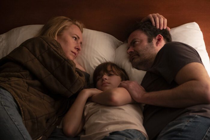 Sally and Barry lay in bed with their sleeping son in between them