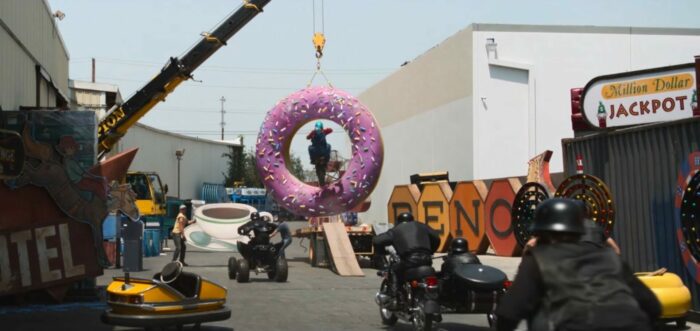 Mrs. Davis S1E1 - Wiley and Simone jump through a giant donut on a motorcycle as the Germans chase them