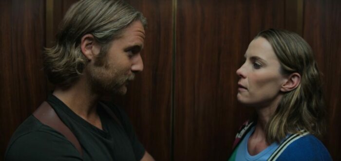 Wiley and Simone facing each other in an elevator, tension between them