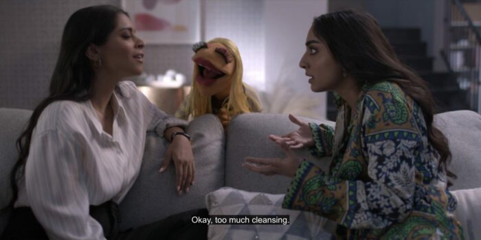 Janice says, "Okay, too much cleansing," to Nora (Lilly Singh) and Hannah Singh (Saara Chaudry), in the TV show, "The Muppets Mayhem."