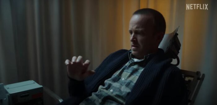 Aaron Paul looks at his hand, which has been shaking