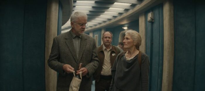 Bernard talks to Mayor Jahns in a hallway, as Marnes follows behind, in Silo S1E3, "Machines"