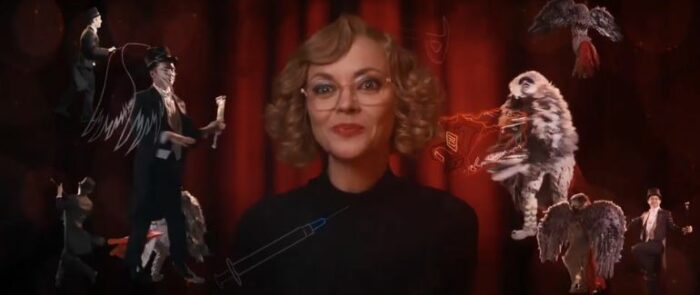 Misty in a black shirt, in front of a red curtain, with animations around her including a syringe and Walter dancing in a suit and hat
