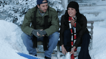 Luke and Lorelai sit on a bench in the snow, Lorelai ties a skate