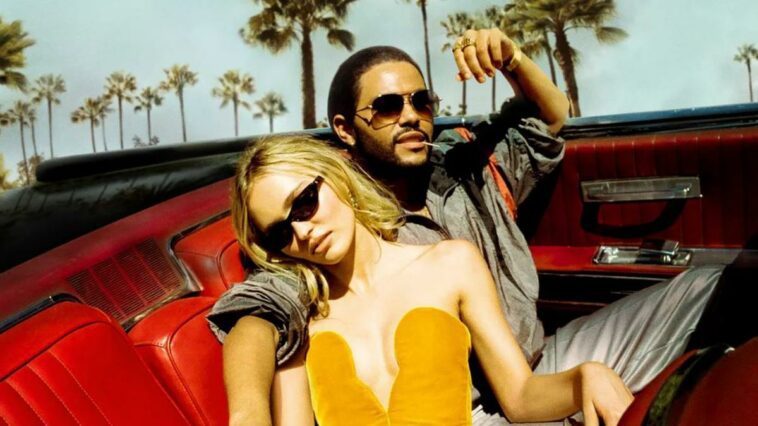 Abel Tesfaye plays Tedros and Lily-Rose Depp plays Jocelyn in The Idol. In this shot from the opening of "Daybreak," they ride together in the backseat of plush, red-seated convertible.