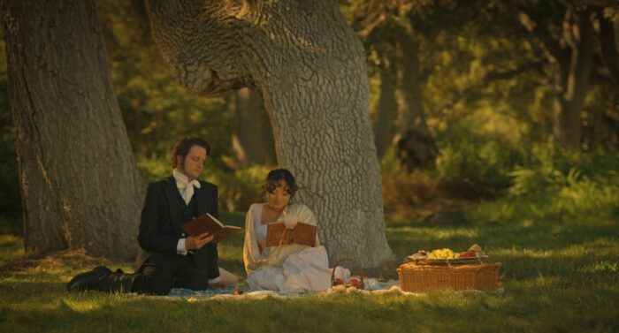 Grace and Edgar sit under a tree, looking 19th century