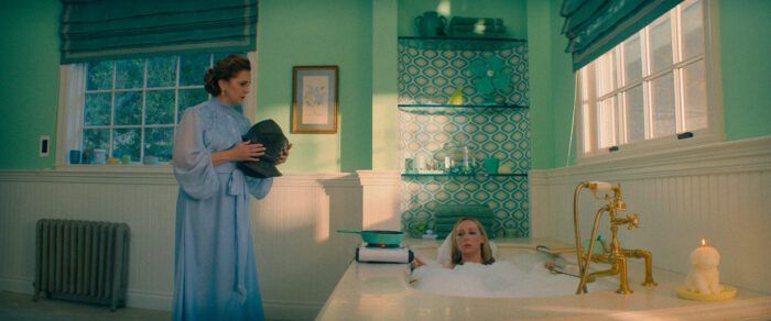 The Afterparty S2E4: L-R Isabel (Elizabeth Perkins) standing by the bathtub, Hannah (Anna Konkle) in the bathtub.