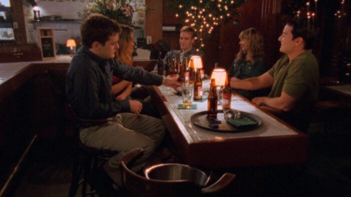 Pacey, Joey, Dawson, Jen, and Jack sit at a table drinking in Dawson's Creek