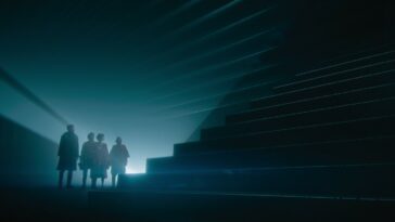Foundation S2E4 - Four people backlit in an enormous dark space with stairs running every which way