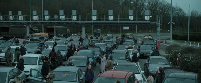Lines of cars and people looking into the sky outside of the Chunnel in England