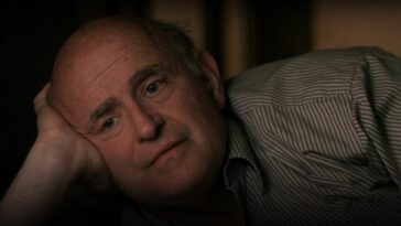 Clyde Bruckman lying on a bed resting his head on his hand