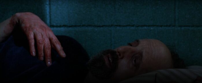 Lanny lies on his bed in a jail cell in The X-Files "Humbug"