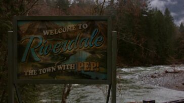 A sign reads Welcome to Riverdale, the town with pep!
