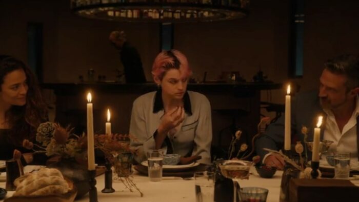 Sian and David talk to each other at the dinner table with Darby sitting in between them