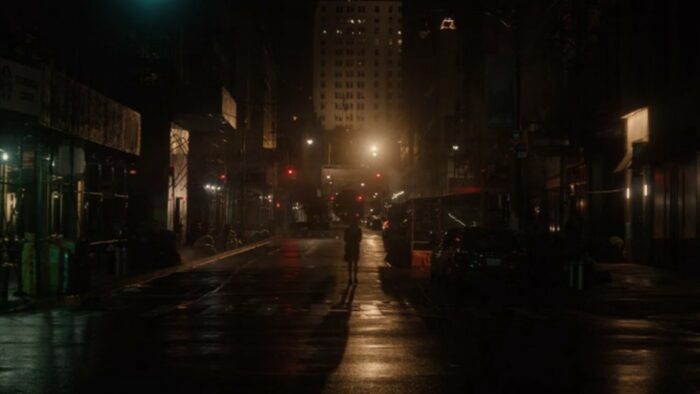 A Murder at the End of the World S1E2 - A dark figure walks down a dark city street