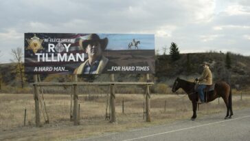 Roy Tillman sits on a horse and admires a billboard of himself.