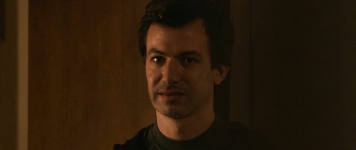 Asher (Nathan Fielder) looks towards the camera right before The Curse S1E1 cuts to black for the end credits