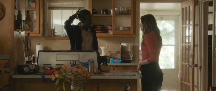 Whitney and Abshir talk in his kitchen