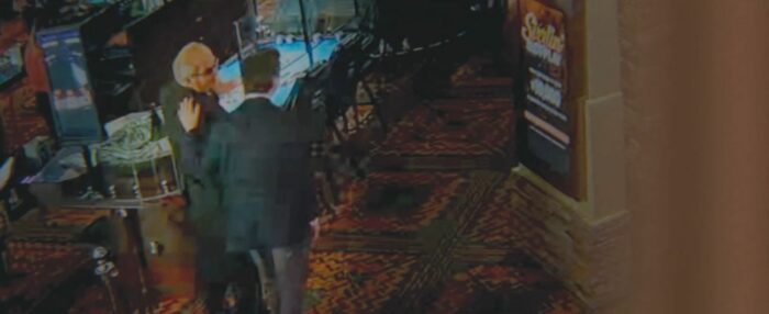 Asher pats a guy on the back in footage from the casino