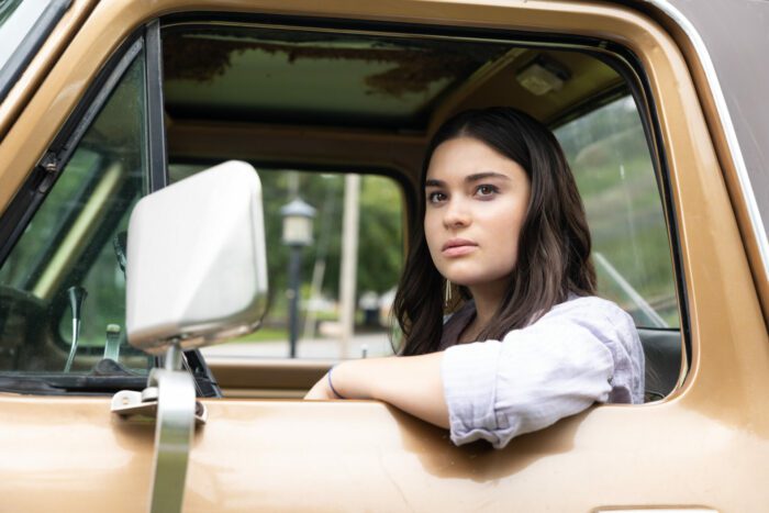 Maya Lopez sits in the driver's seat of a truck with an arm out the window