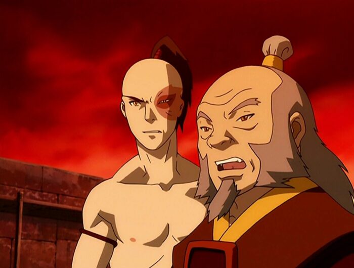 Iroh and Zuko looking toward the left with a deep red sky in the background