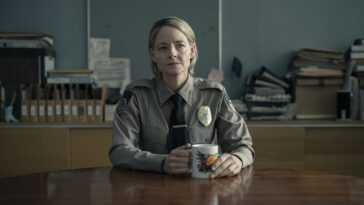 Danvers sits at a desk in uniform in the finale of True Detective: Night Country (Part 6)