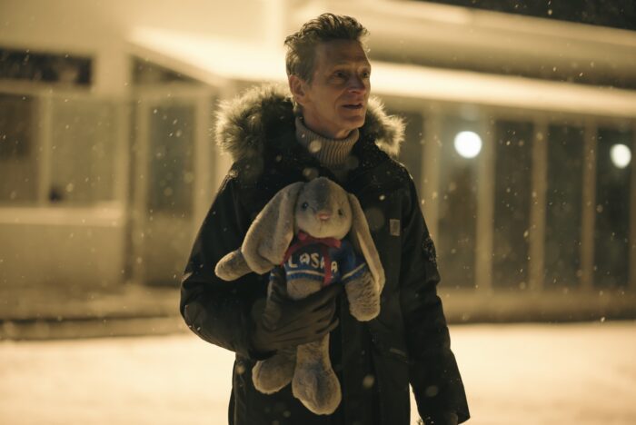 Hank Prior holds a stuffed rabbit as he waits at the airport