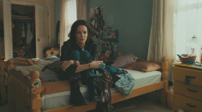 Rebecca sits on Jo's bed in Seven Oaks