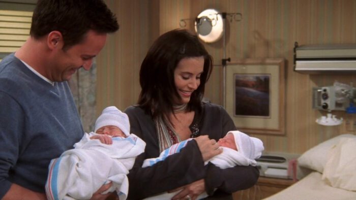 Chandler and Monica each hold a baby in the series finale of Friends