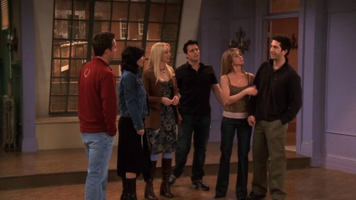 Chandler, Monica, Phoebe, Joey, Rachel, and Ross stand in an empty apartment in the series finale of Friends