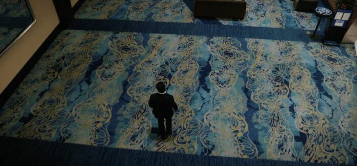 John Sugar, walking across a patterned floor in Japan