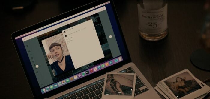 Olivia on a laptop screen, Polaroids of Rachel, and a bottle of scotch, on a table